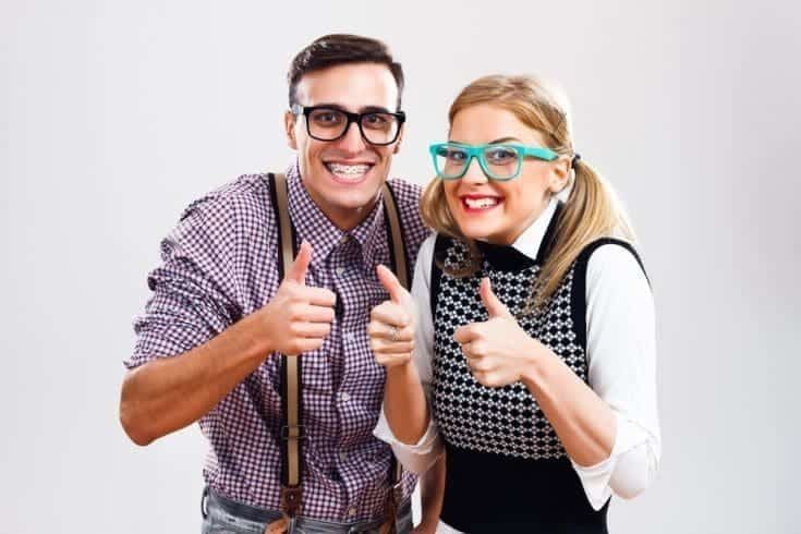 A couple showing thumbs up they love being nerds.