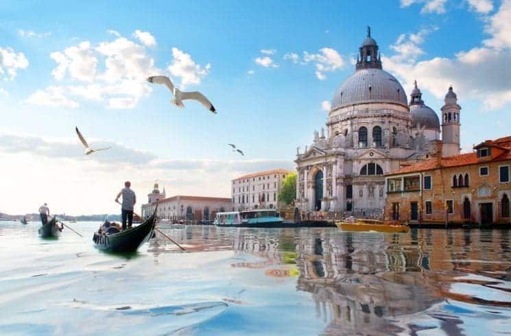 Flying Seagulls and old cathedral of Santa Maria della Salute in Venice, Italy