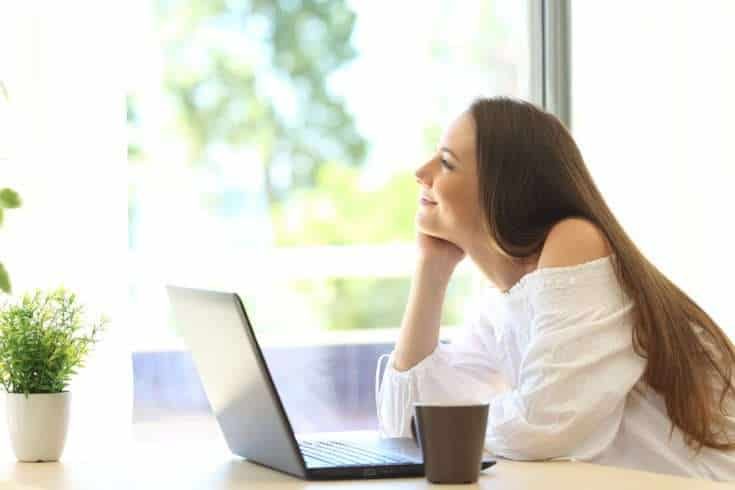 Woman daydreaming while working