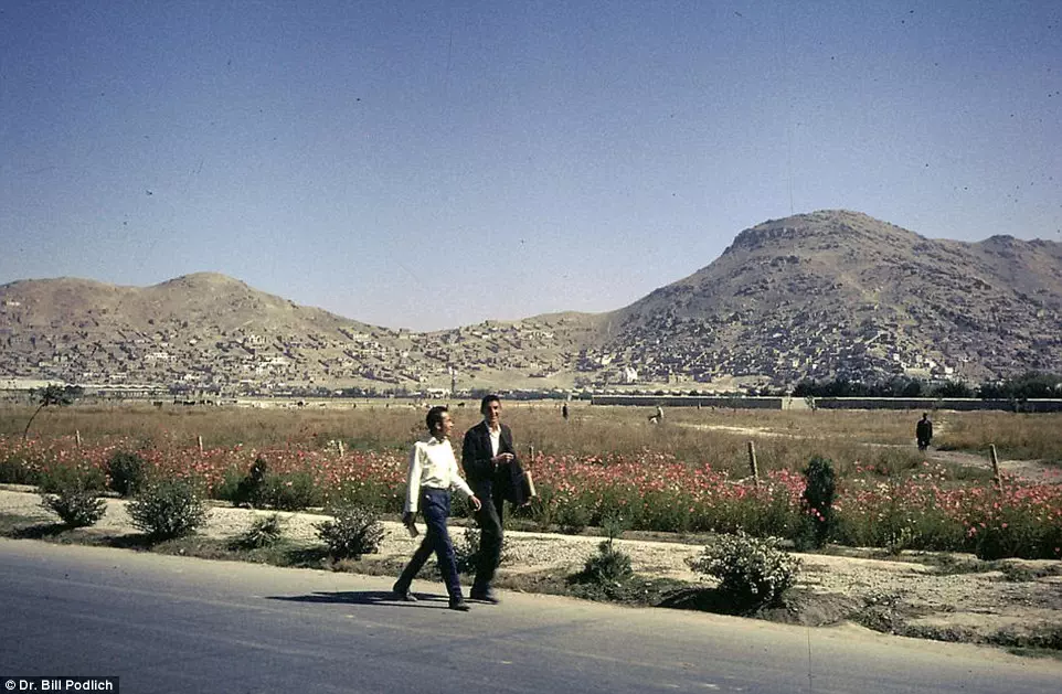 Not a bad commute: Young Afghans walking home with spectacular scenery visible in the distance