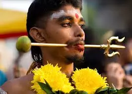 Devotees piercing their cheeks during thaipsum festival