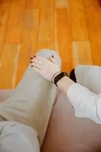 woman touching mans knee