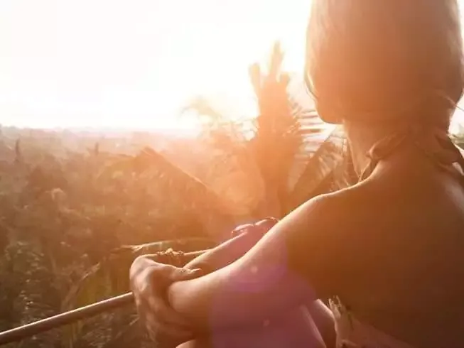 Vacationland: 18 Best Island Getaways 8 Lonely woman standing on the balcony