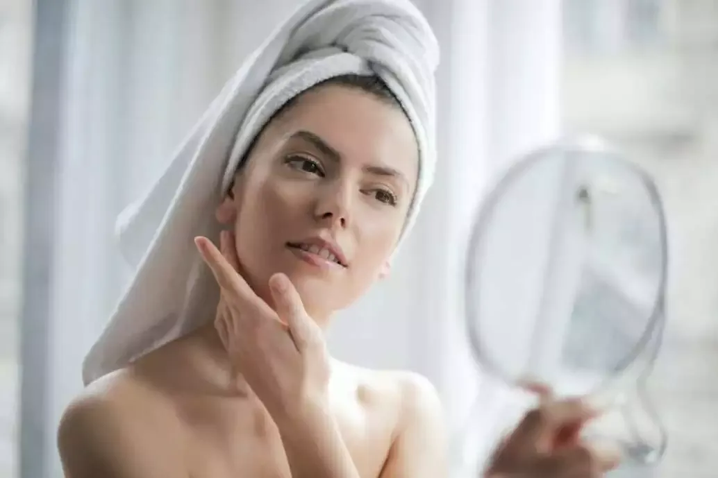How to Do Makeup at Home (Best Guide of 2022) 8 woman applying makeup primer