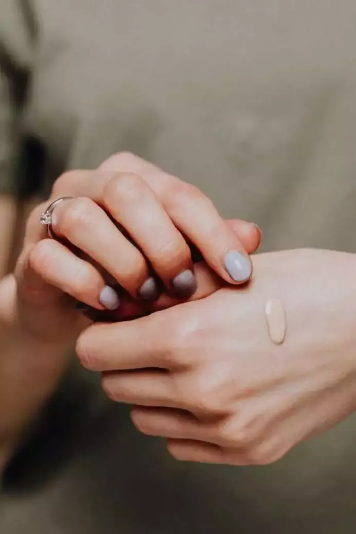 How to Do Makeup at Home (Best Guide of 2022) 9 Putting foundation on the back of the hand