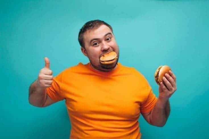 15 Types of Friends in Every Group, The Good & Bad You Should Know 16 Man eating burgers because he loves food.