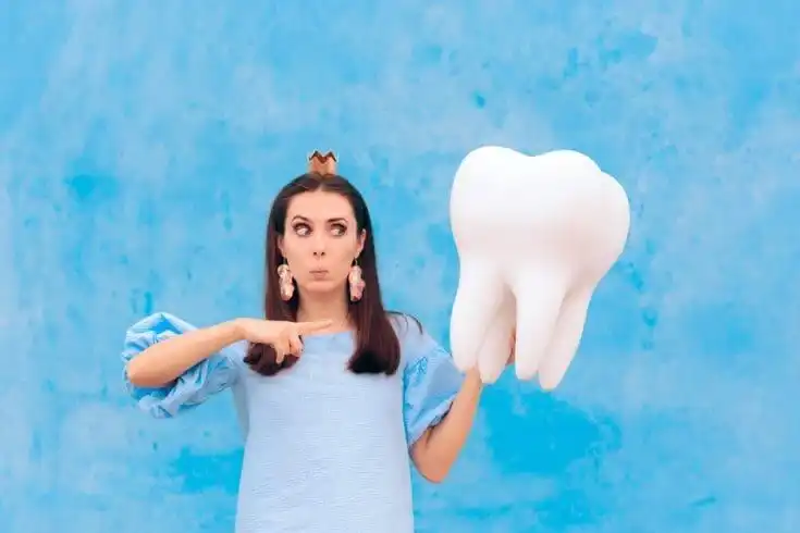 The "TEETH FALLING OUT" Dream 1 A woman holding a big tooth