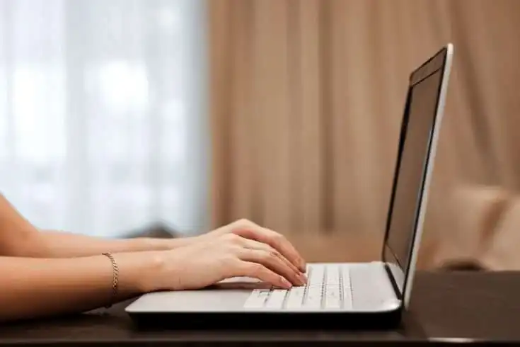 Writing: It's A Process 8 Woman typing on laptop