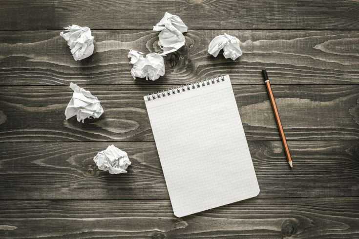 Writing: It's A Process 10 Crumbled paper balls and a note pad placed on a table