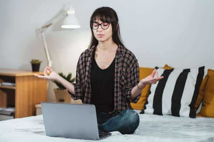 10 New Year resolutions to make college life better in 2016 9 Calm and composed woman sitting on the bed meditating.