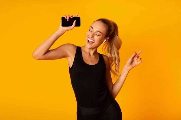 5 Affordable Gadgets With Awesome Features 9 woman wearing earbuds and enjoying music