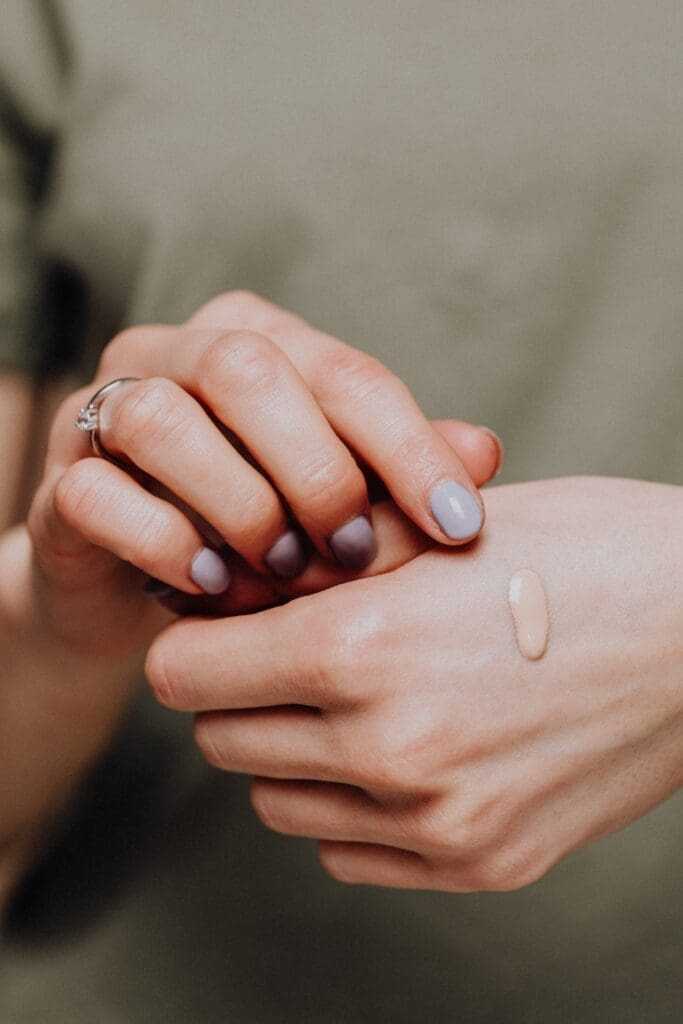 How to Do Makeup at Home (Best Guide of 2022) 10 Putting foundation on the back of the hand