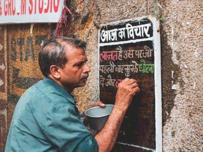 20 Unique Ways to Show Gratitude: Thank You in Different Languages 16 Man writing on blackboard in Hindi