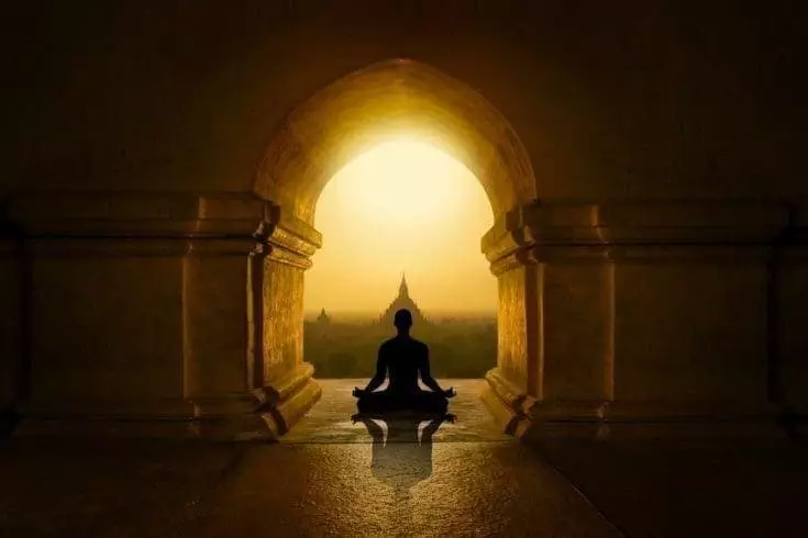 Man meditating in a budhist temple