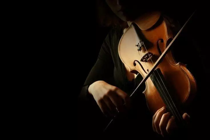 Close up of a person playing violin