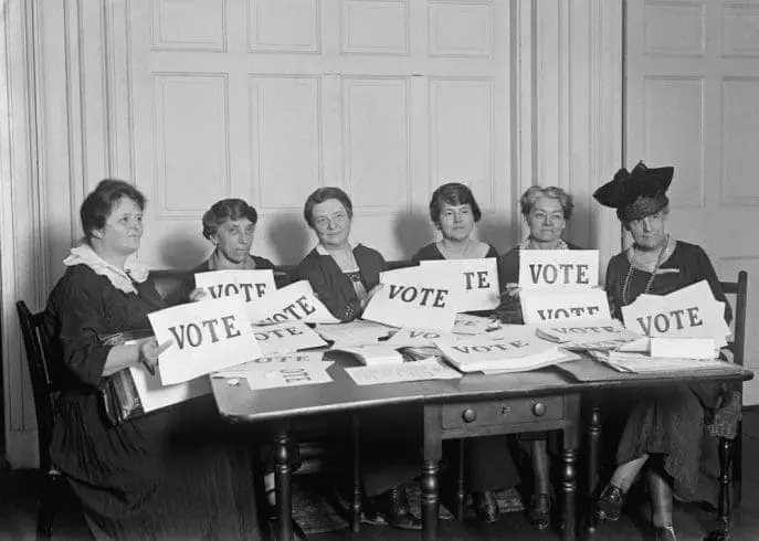 Women holding vote cards