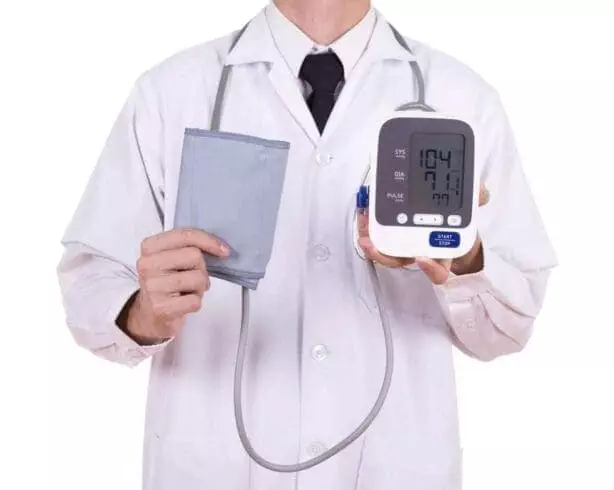 doctor with digital blood pressure monitor isolated on white background