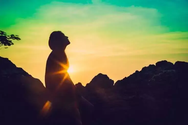 Silhouette of a woman sitting alone in late evening