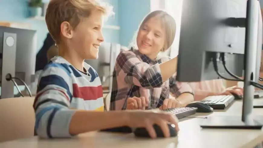 A young boy and girl sitting together in the class