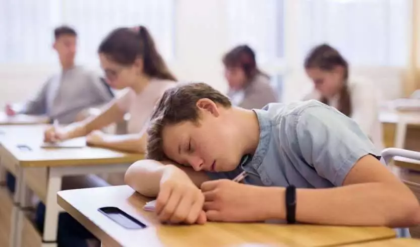 Teenager sleeping in the classroom