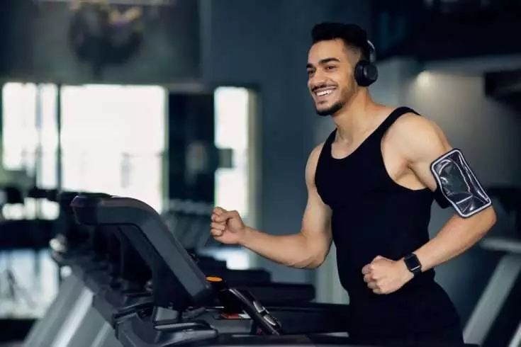 Man listening to music while gymming