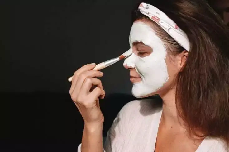 face cream application by woman