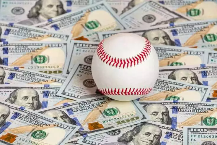 Baseball with cash money. Major league strike, lockout and sports betting concept.