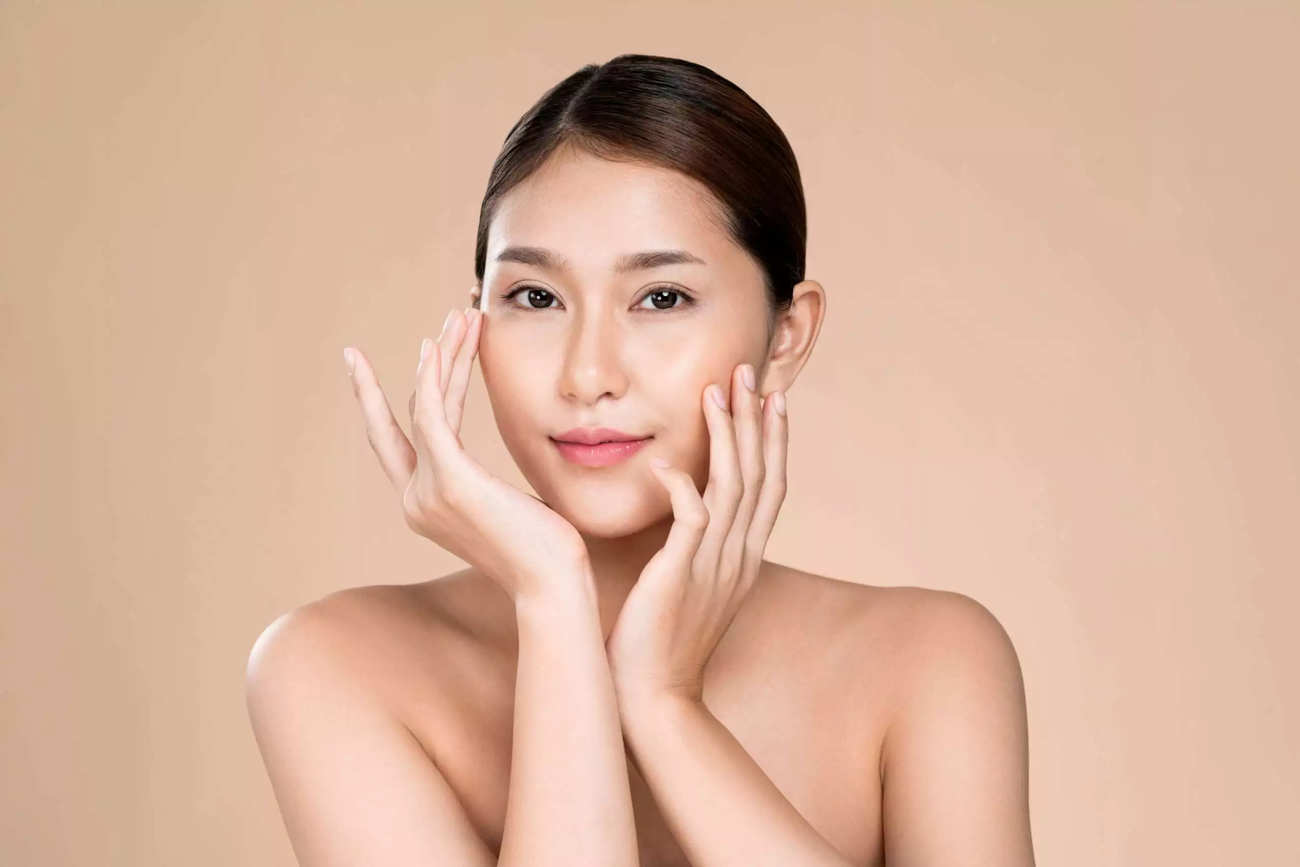 Portrait of ardent young woman with healthy clear skin and soft makeup looking at camera and posing beauty gesture. Cosmetology skincare and beauty concept. - korean plastic surgery